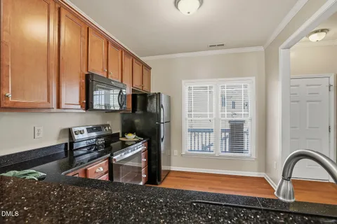 a kitchen with stainless steel appliances granite countertop a stove a refrigerator and a microwave