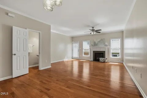 a view of an empty room with a fireplace and a window