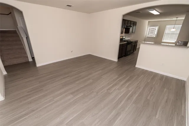 a view of a kitchen with wooden floor and a sink