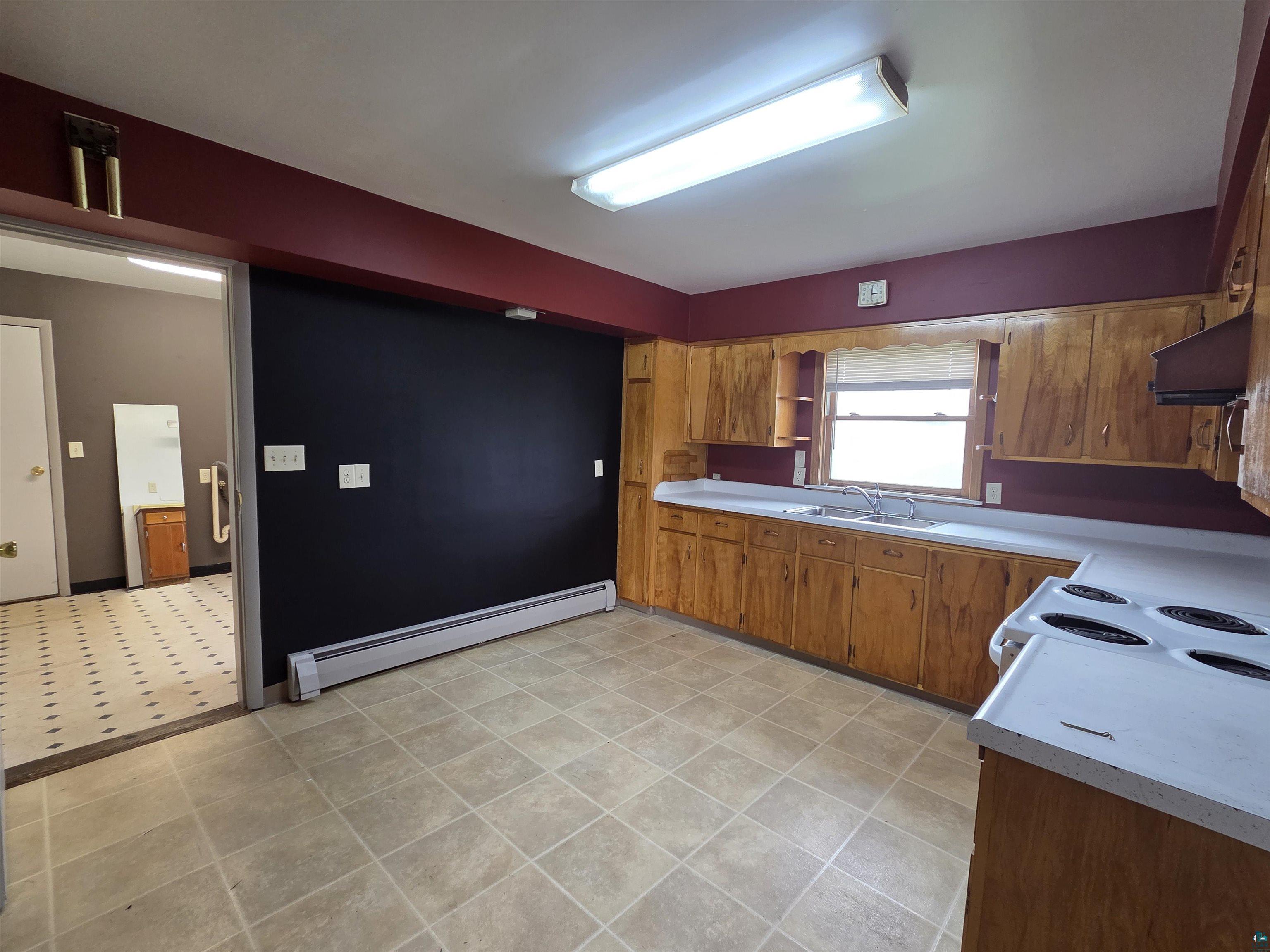 56 East 2nd Street Superior, WI 54880 - Photo 6 of 18 Kitchen featuring wood cabinetry, white countertops, and a white electric range