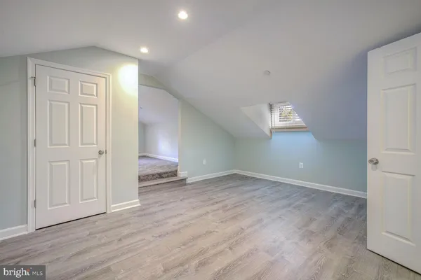 a view of an empty room and wooden floor