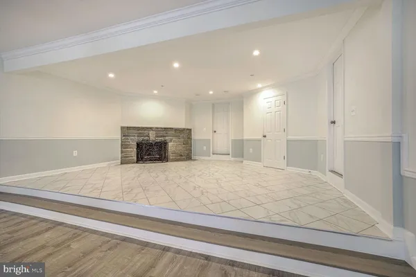 a large white kitchen with kitchen island sink and refrigerator