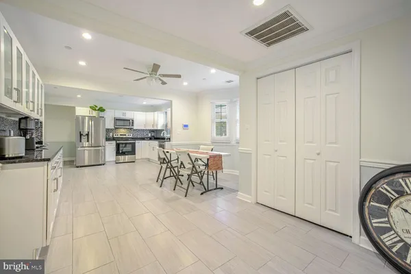 a view of a kitchen with furniture and a refrigerator