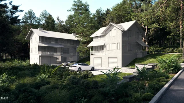 a view of a house with a small yard and large trees