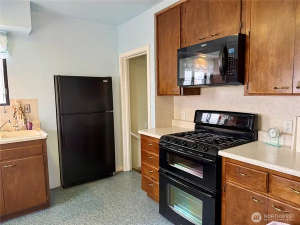 a kitchen with a refrigerator stove and microwave