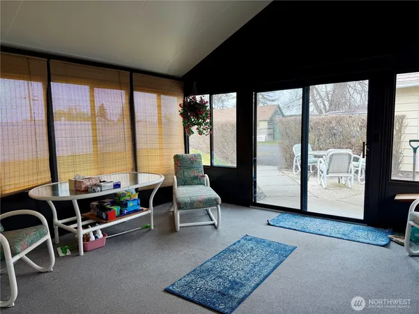 a living room with furniture and floor to ceiling window