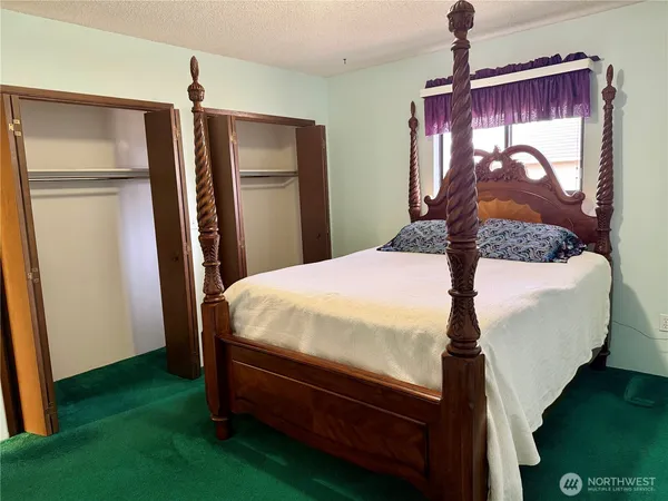 a bed sitting in a room next to a window