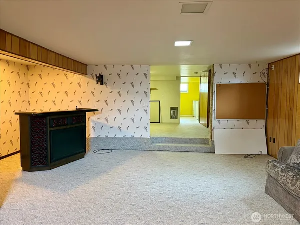 a view of kitchen with refrigerator and window