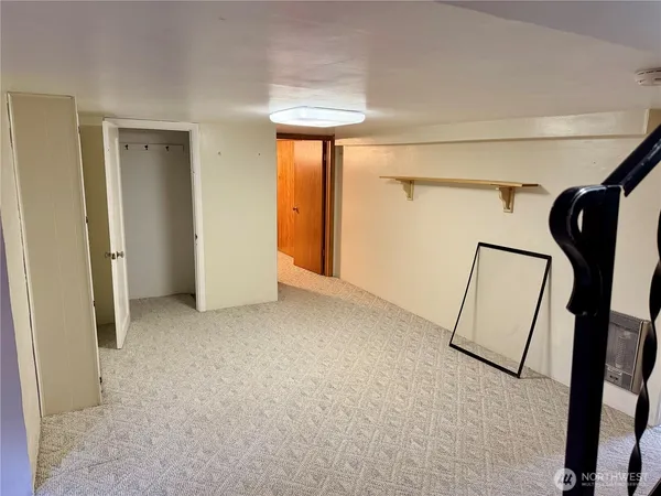 a view of a room with staircase and mirror