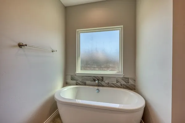 a white bath tub sitting in a bathroom