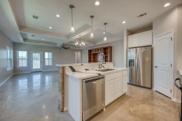 a kitchen with a sink stainless steel appliances and window