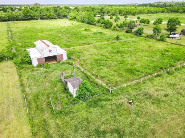 a aerial view of a house with a yard and lake view