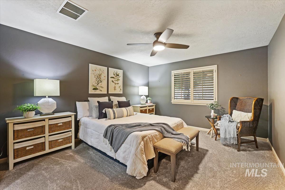 647 North Shadowfox Place Eagle, ID 83616 - Photo 14 of 35 Newly carpeted bedroom with a textured ceiling and a ceiling fan
