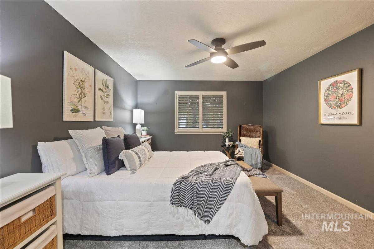 647 North Shadowfox Place Eagle, ID 83616 - Photo 16 of 35 Newly carpeted bedroom with a ceiling fan and built in shutters
