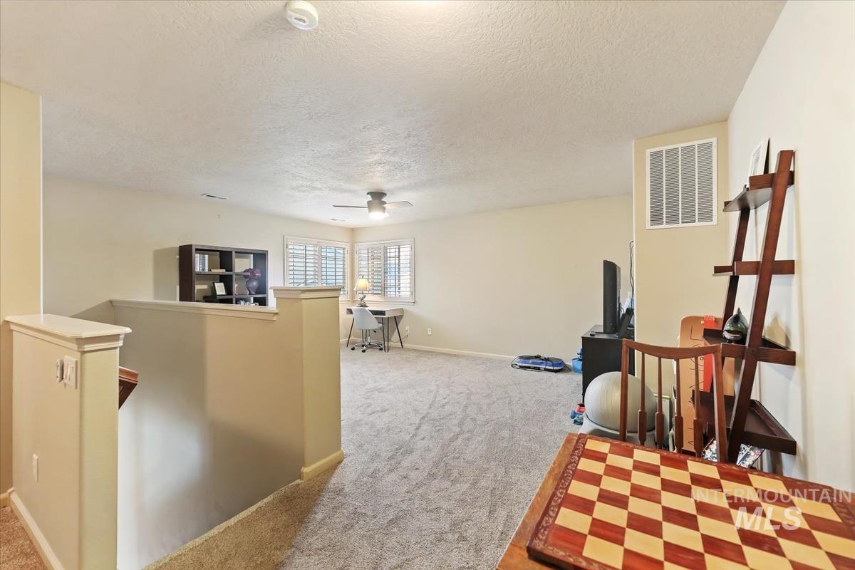 647 North Shadowfox Place Eagle, ID 83616 - Photo 25 of 35 Hallway with an upstairs landing and new carpet on stairs