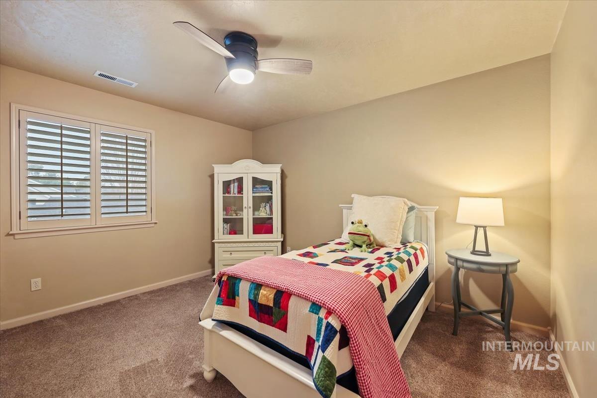 647 North Shadowfox Place Eagle, ID 83616 - Photo 29 of 35 Bedroom featuring newer carpet and a ceiling fan