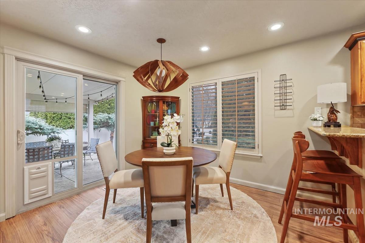 647 North Shadowfox Place Eagle, ID 83616 - Photo 6 of 35 Dining area featuring LVP and modern chandelier