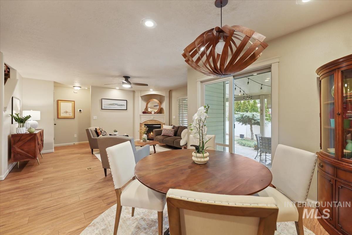 647 North Shadowfox Place Eagle, ID 83616 - Photo 7 of 35 Dining area with LVP flooring and modern chandelier