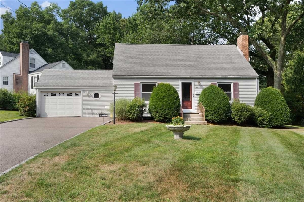 front view of a house with yard and trees