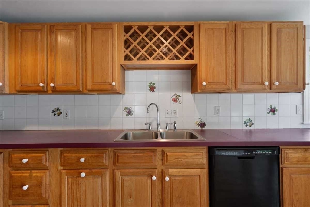 23 Marshall Road Natick, MA 01760 - Photo 11 of 31 a kitchen with stainless steel appliances granite countertop a sink dishwasher and cabinets with wooden floor