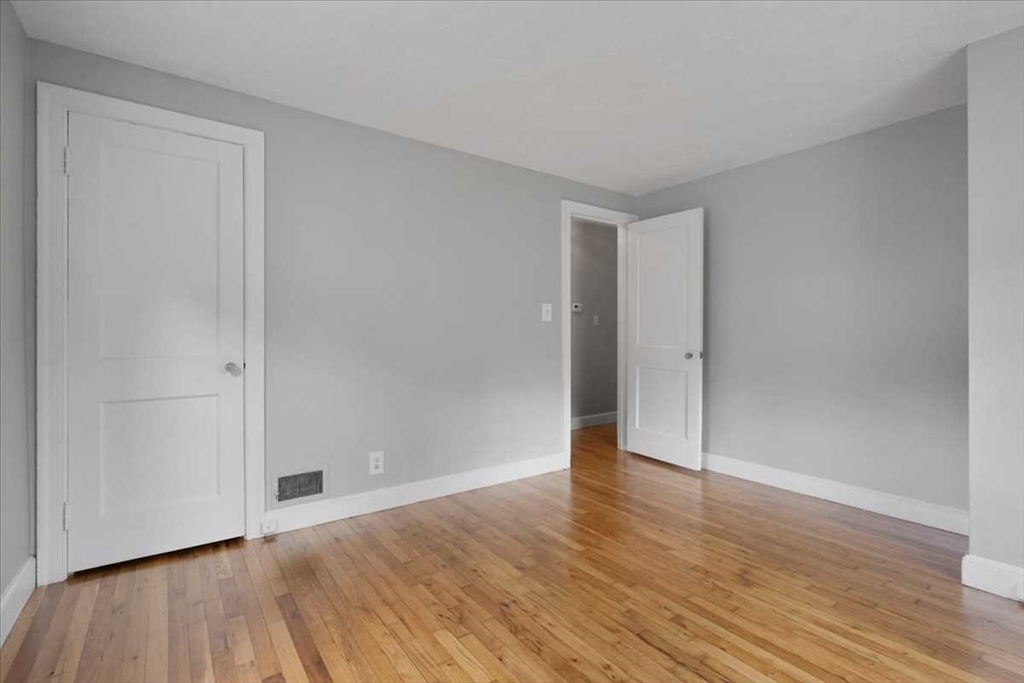 23 Marshall Road Natick, MA 01760 - Photo 12 of 31 a view of an empty room with wooden floor
