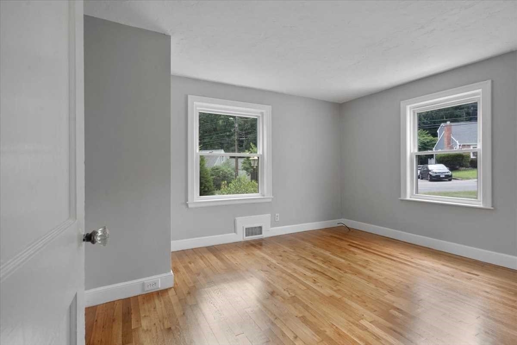 23 Marshall Road Natick, MA 01760 - Photo 13 of 31 a view of an empty room with window and wooden floor