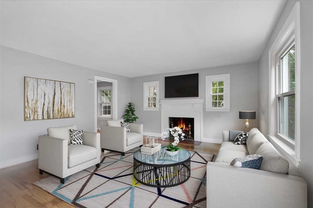 23 Marshall Road Natick, MA 01760 - Photo 2 of 31 a living room with furniture a fireplace and a flat screen tv