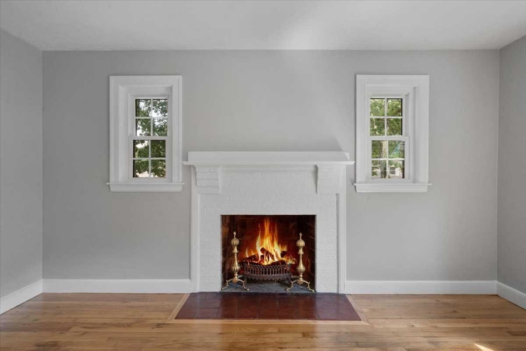 23 Marshall Road Natick, MA 01760 - Photo 4 of 31 a living room with a fireplace and a wooden floor