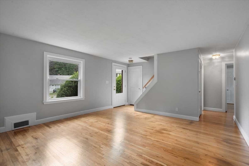 23 Marshall Road Natick, MA 01760 - Photo 5 of 31 a view of an empty room with wooden floor and a window