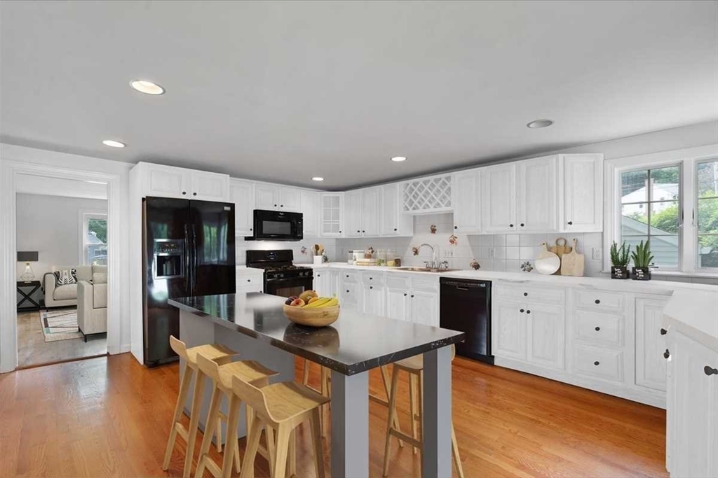 23 Marshall Road Natick, MA 01760 - Photo 8 of 31 a kitchen with cabinets and wooden floor