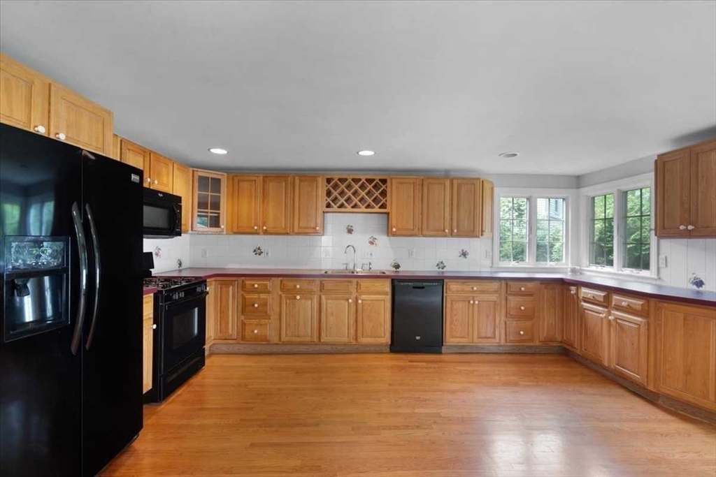 23 Marshall Road Natick, MA 01760 - Photo 10 of 31 a large kitchen with granite countertop a stove a sink dishwasher a refrigerator and a oven