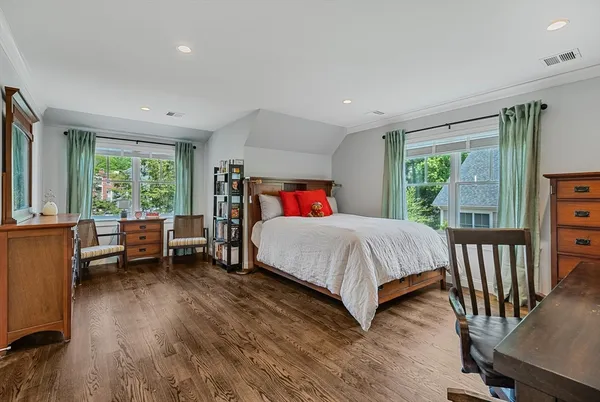 a bedroom with a large bed and a windows