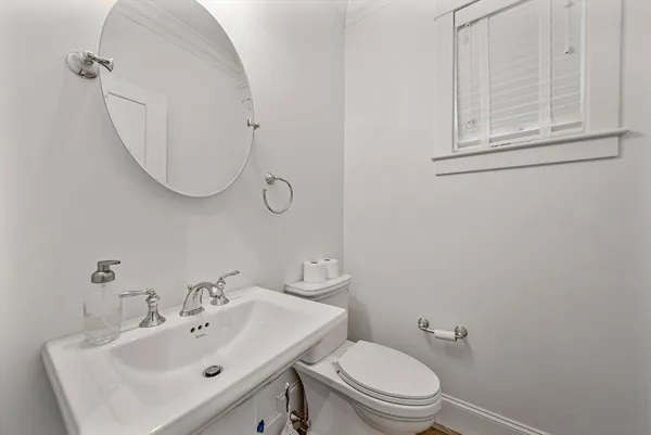a bathroom with a sink a mirror and toilet