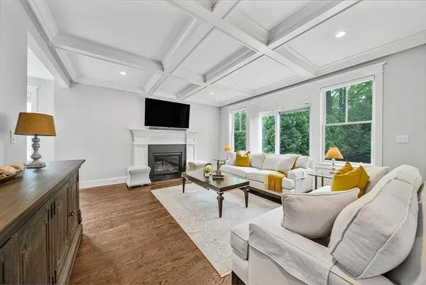 a living room with furniture fireplace and a flat screen tv