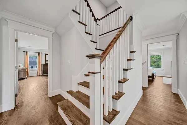 a view of an entryway with wooden floor and a livingroom view