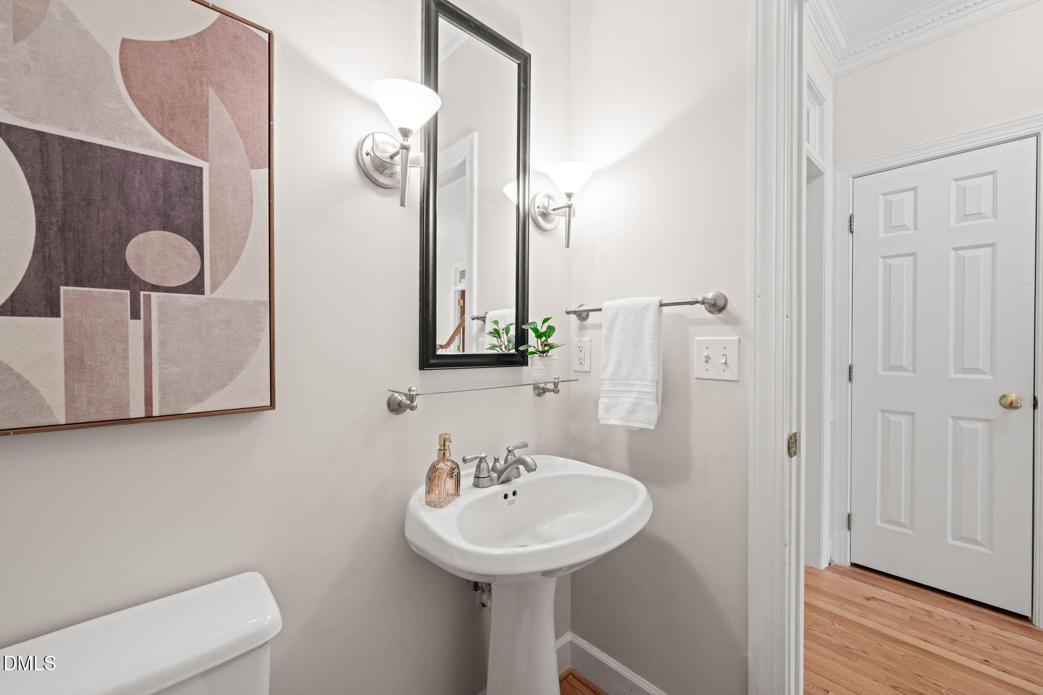 5809 Stone Spring Road Raleigh, NC 27613 - Photo 16 of 54 a bathroom with a toilet sink and mirror