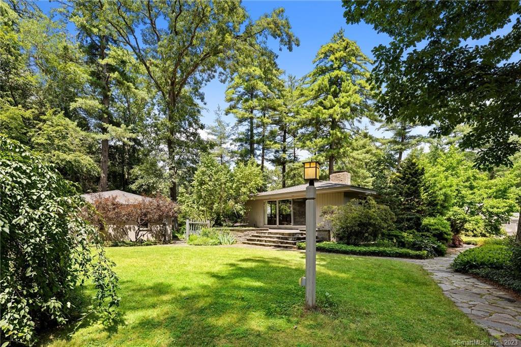 44 Wheeler Road Simsbury, CT 06070 - Photo 1 of 1 a backyard of a house with table and chairs