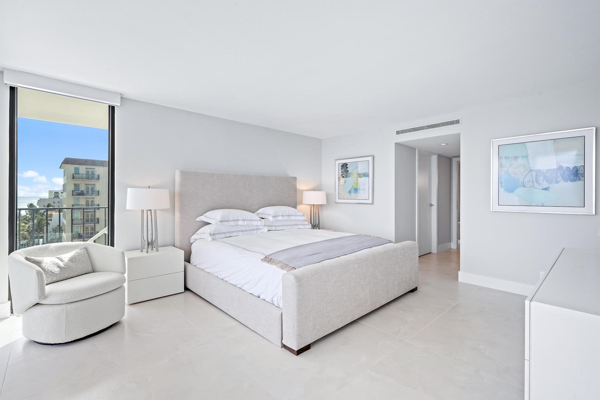 3456 South Ocean Boulevard, Unit 701 Palm Beach, FL 33480 - Photo 11 of 20 a bedroom with a large bed and a couch