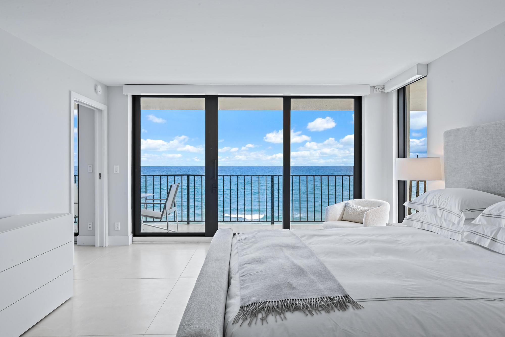 3456 South Ocean Boulevard, Unit 701 Palm Beach, FL 33480 - Photo 12 of 20 a bedroom with a large bed and a large window