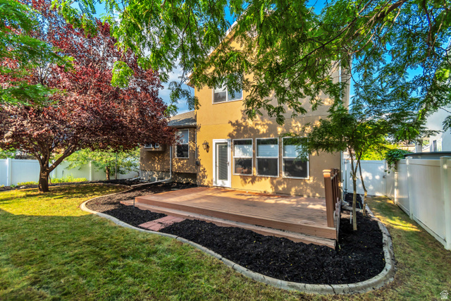 11798 Spiraea Way Draper, UT 84020 - Photo 20 of 21 Rear exterior featuring a spacious wood deck, stucco siding, and multiple windows