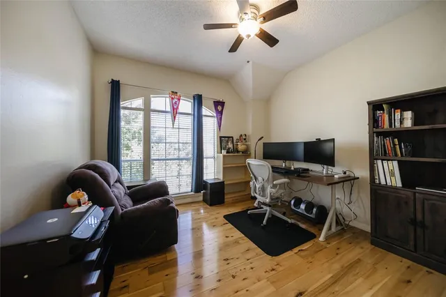a view of a livingroom with workspace and a window