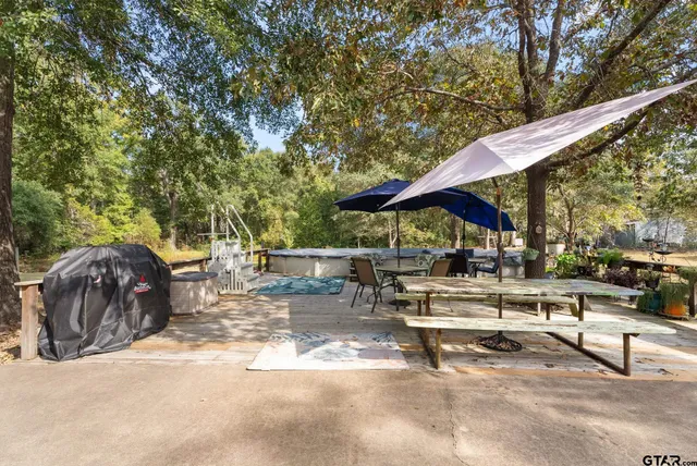 a view of backyard with swimming pool and sitting area