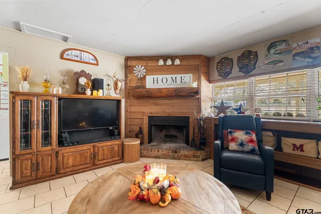 a living room with furniture a flat screen tv and a fireplace