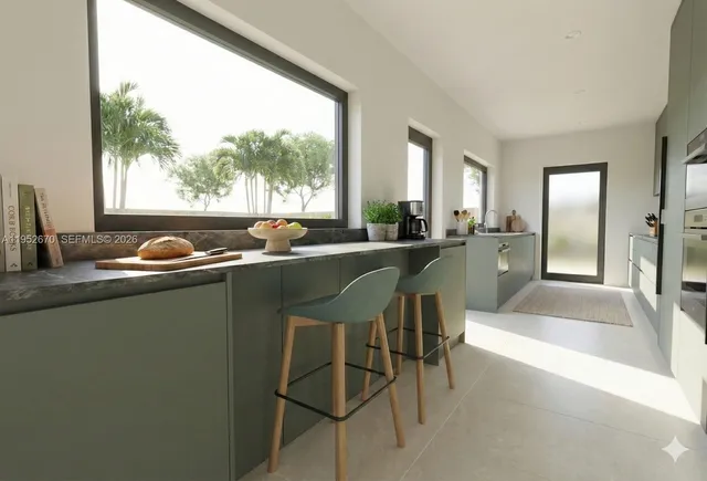 a view of a dining room with furniture and large windows