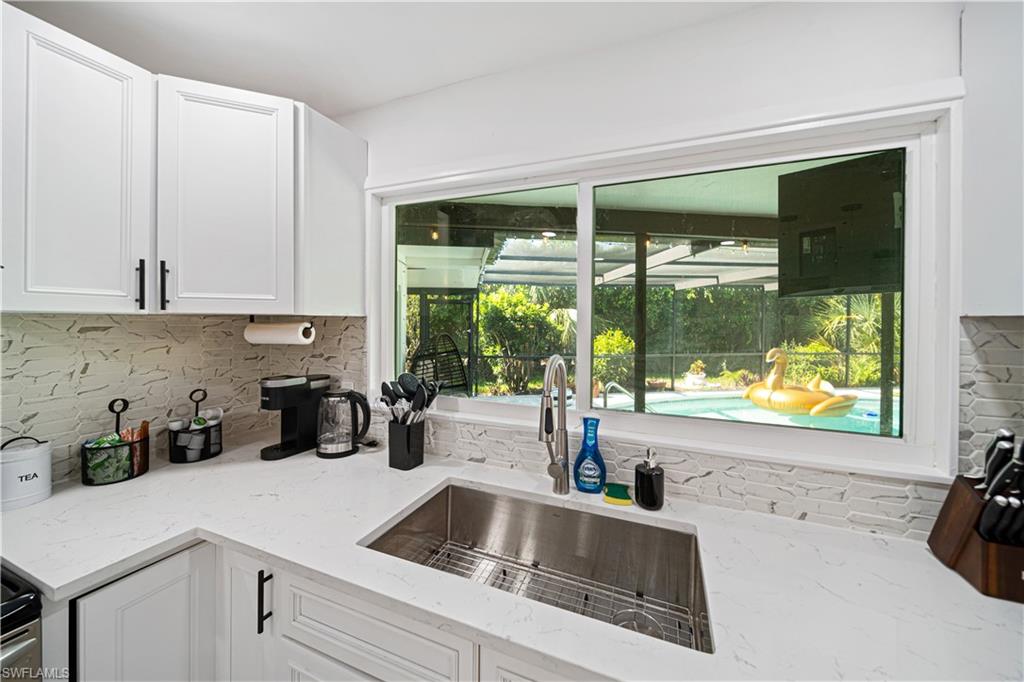 4439 Parrot Avenue Naples, FL 34104 - Photo 12 of 39 a kitchen with a sink and a large window
