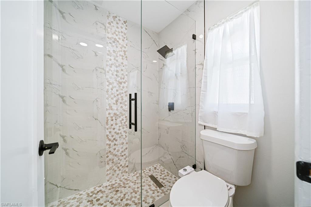4439 Parrot Avenue Naples, FL 34104 - Photo 20 of 39 a bathroom with a toilet and a shower
