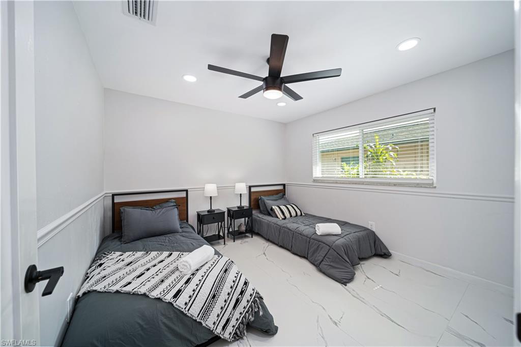 4439 Parrot Avenue Naples, FL 34104 - Photo 22 of 39 a bedroom with a bed and window