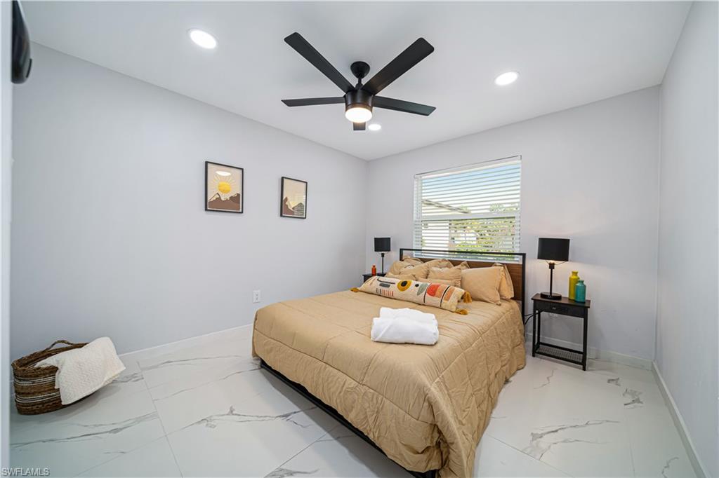 4439 Parrot Avenue Naples, FL 34104 - Photo 23 of 39 a bedroom with a bed and window