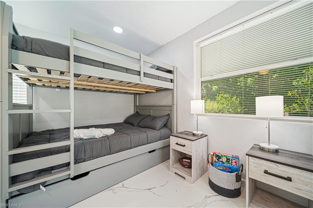 4439 Parrot Avenue Naples, FL 34104 - Photo 28 of 39 a bedroom with a bed and a window