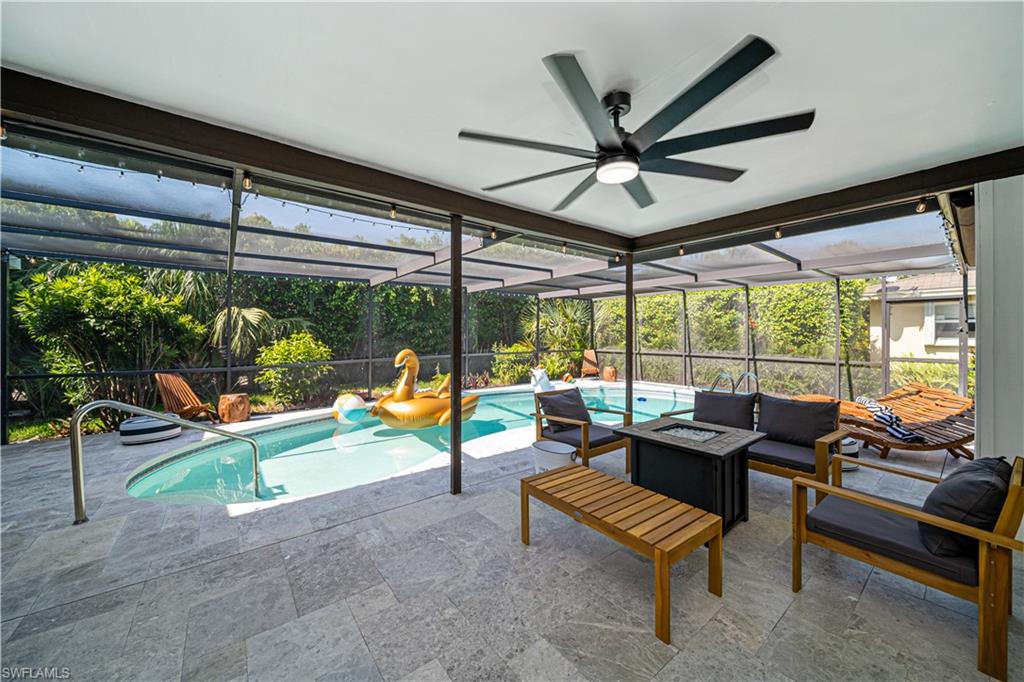 4439 Parrot Avenue Naples, FL 34104 - Photo 31 of 39 a living room with furniture and a floor to ceiling window